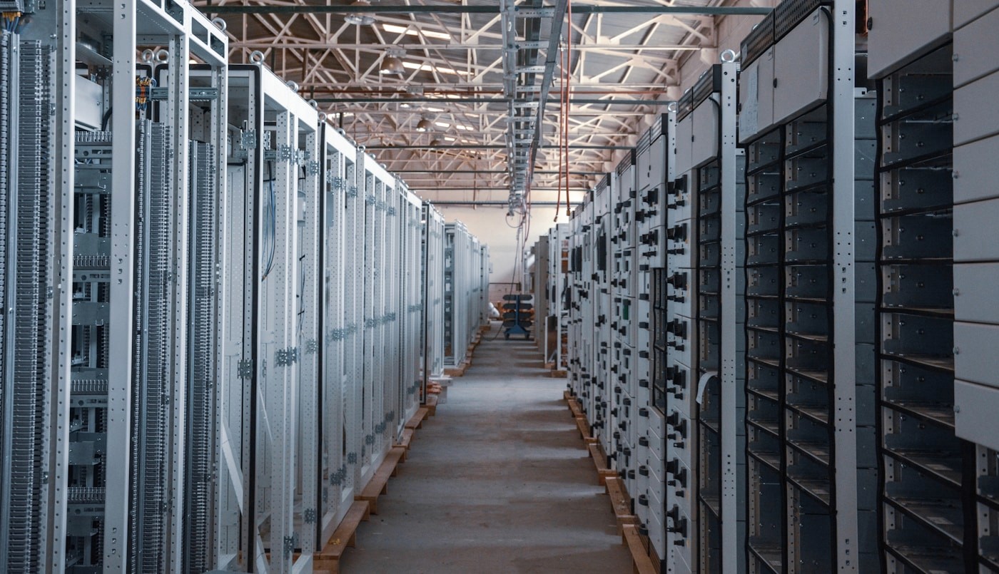 Long aisle of electrical switchgear cabinets under construction